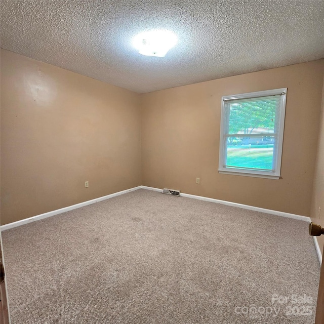 6573 Weldon Cir NW Unit 22, Concord, NC 28027 - carpeted spare room featuring a textured ceiling and baseboards