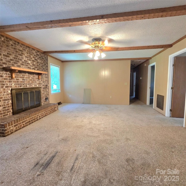 6573 Weldon Cir NW Unit 22, Concord, NC 28027 - unfurnished living room with beam ceiling, ceiling fan, a textured ceiling, carpet floors, and a brick fireplace