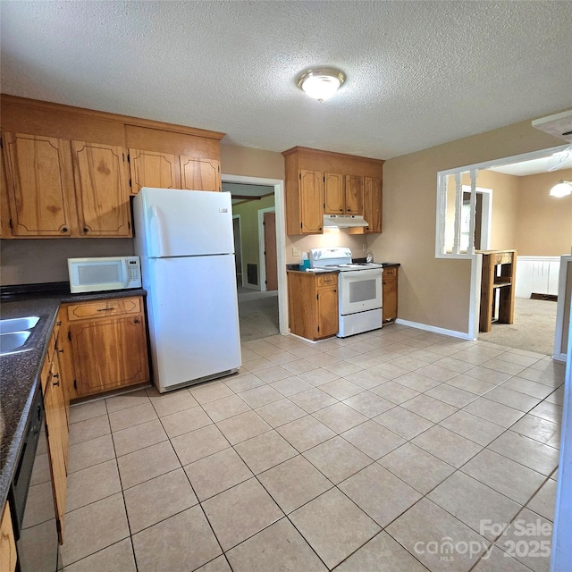 6573 Weldon Cir NW Unit 22, Concord, NC 28027 - kitchen with white appliances, under cabinet range hood, a textured ceiling, light tile patterned floors, and brown cabinetry