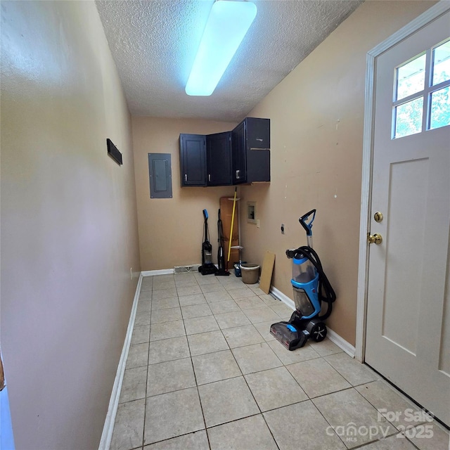 6573 Weldon Cir NW Unit 22, Concord, NC 28027 - washroom with washer hookup, a textured ceiling, electric panel, baseboards, and light tile patterned flooring