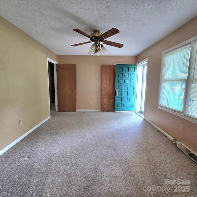 6573 Weldon Cir NW Unit 22, Concord, NC 28027 - unfurnished room featuring baseboards, ceiling fan, a textured ceiling, and carpet floors
