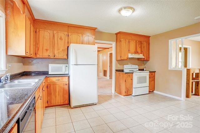 6573 Weldon Cir NW Unit 22, Concord, NC 28027 - kitchen with white appliances, under cabinet range hood, a textured ceiling, and light tile patterned floors