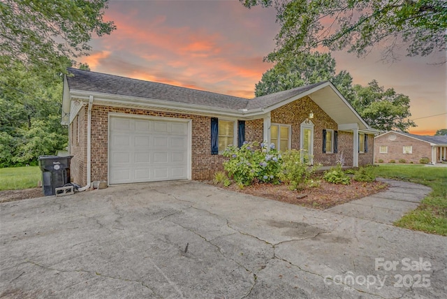 6573 Weldon Cir NW Unit 22, Concord, NC 28027 - view of front facade featuring brick siding, a garage, driveway, and a shingled roof