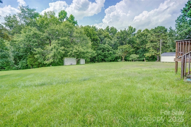 6573 Weldon Cir NW Unit 22, Concord, NC 28027 - view of yard featuring a shed and a view of trees