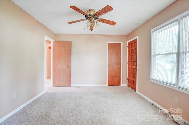 6573 Weldon Cir NW Unit 22, Concord, NC 28027 - carpeted empty room featuring plenty of natural light and a ceiling fan