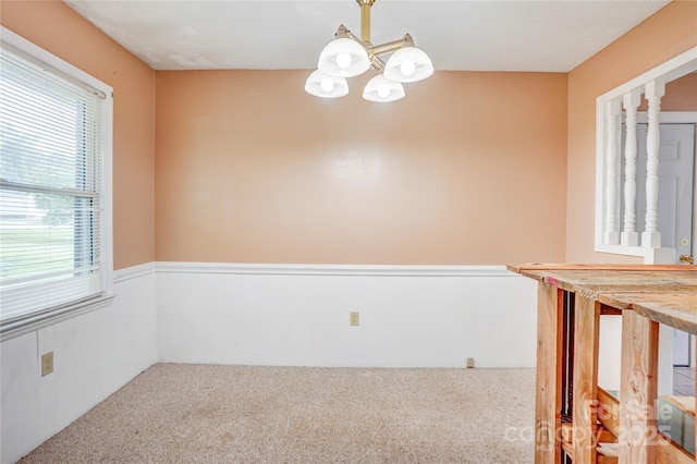 6573 Weldon Cir NW Unit 22, Concord, NC 28027 - carpeted empty room with a chandelier and a wainscoted wall