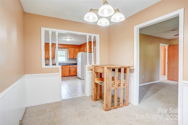 6573 Weldon Cir NW Unit 22, Concord, NC 28027 - corridor featuring a chandelier, light colored carpet, and wainscoting