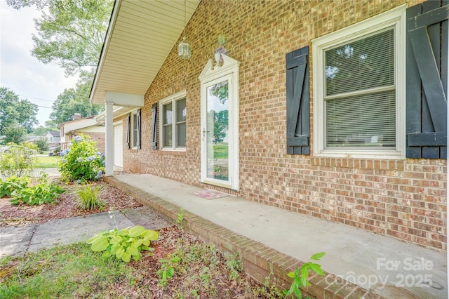 6573 Weldon Cir NW Unit 22, Concord, NC 28027 - view of side of property featuring brick siding and a porch