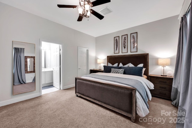 bedroom with light carpet, baseboards, ensuite bathroom, and ceiling fan