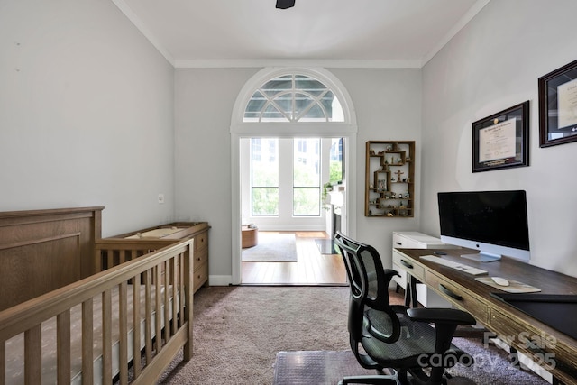 carpeted bedroom featuring ornamental molding, a desk, and baseboards