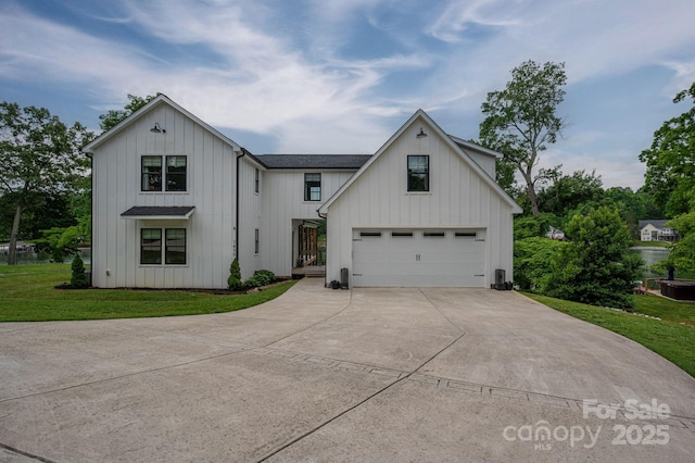 modern inspired farmhouse featuring concrete driveway, board and batten siding, and a front lawn