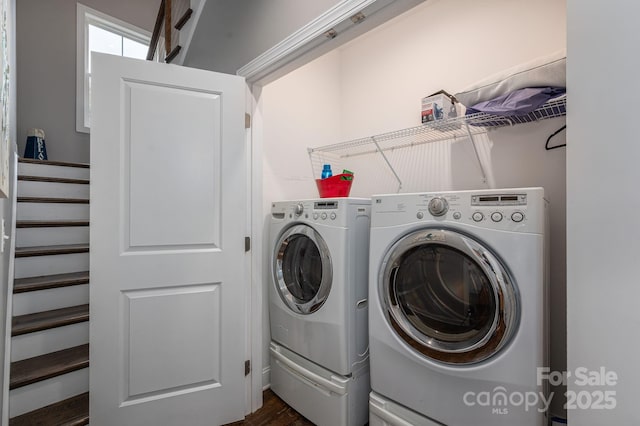 laundry area with independent washer and dryer and dark wood-style flooring