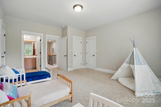 15714 Laurel Oak Cres, Davidson, NC 28036 - carpeted bedroom featuring baseboards and connected bathroom