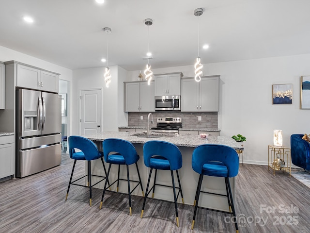 6381 Trinity Crossing Cir, Kannapolis, NC 28081 - kitchen with stainless steel appliances, a sink, gray cabinetry, dark wood-type flooring, and recessed lighting