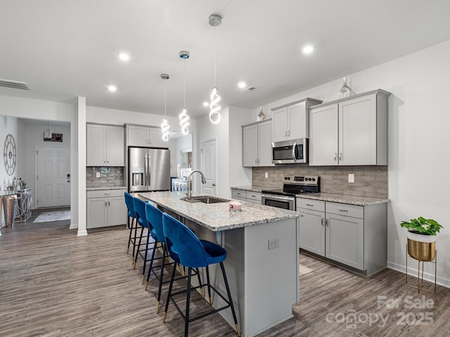 6381 Trinity Crossing Cir, Kannapolis, NC 28081 - kitchen with stainless steel appliances, a sink, gray cabinetry, backsplash, and recessed lighting