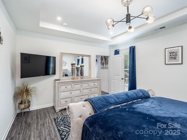 6381 Trinity Crossing Cir, Kannapolis, NC 28081 - bedroom featuring a chandelier, dark wood-style flooring, a tray ceiling, and baseboards
