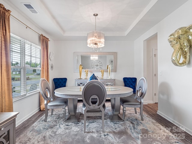 6381 Trinity Crossing Cir, Kannapolis, NC 28081 - dining area with a tray ceiling, a chandelier, wood finished floors, and baseboards