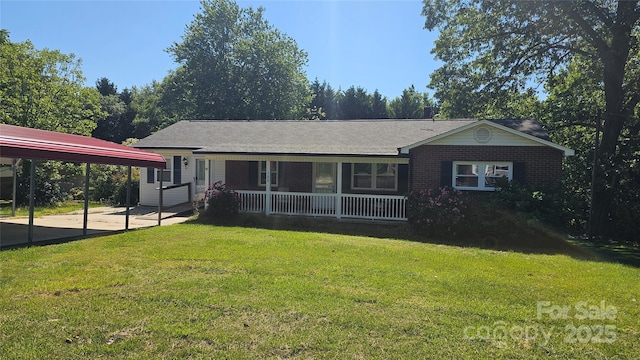 single story home featuring covered porch, a front lawn, a detached carport, and brick siding