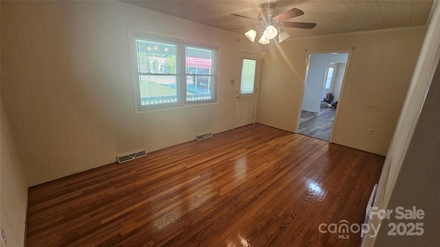 empty room featuring wood finished floors and ceiling fan