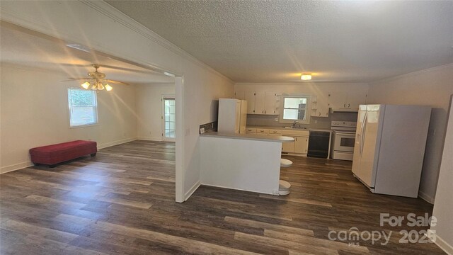 kitchen with range with electric stovetop, dishwasher, freestanding refrigerator, crown molding, and a sink