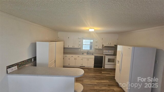 kitchen with white appliances, crown molding, a sink, under cabinet range hood, and dark wood finished floors