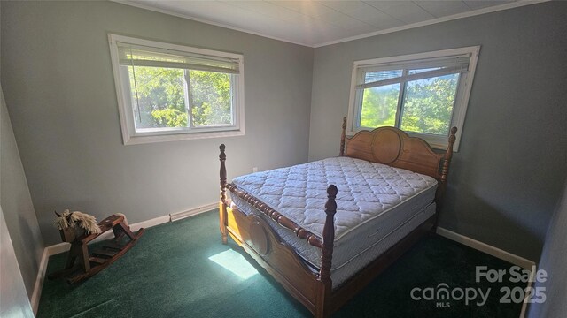 carpeted bedroom featuring ornamental molding, multiple windows, and baseboards
