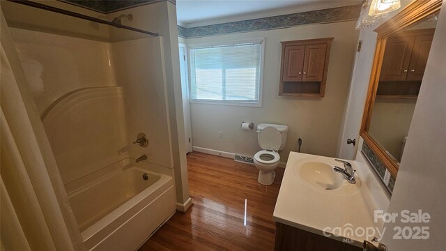 bathroom featuring wood finished floors, bathtub / shower combination, toilet, baseboards, and vanity