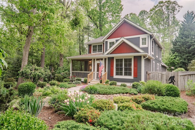 view of front of property with fence and a porch