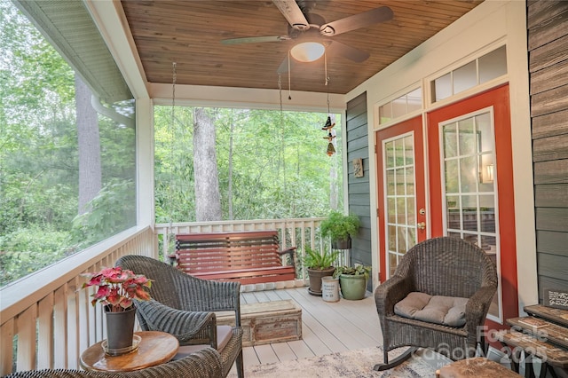 wooden deck featuring a ceiling fan and french doors