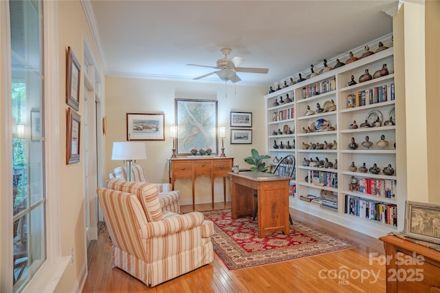 office space with ceiling fan, light wood finished floors, and crown molding