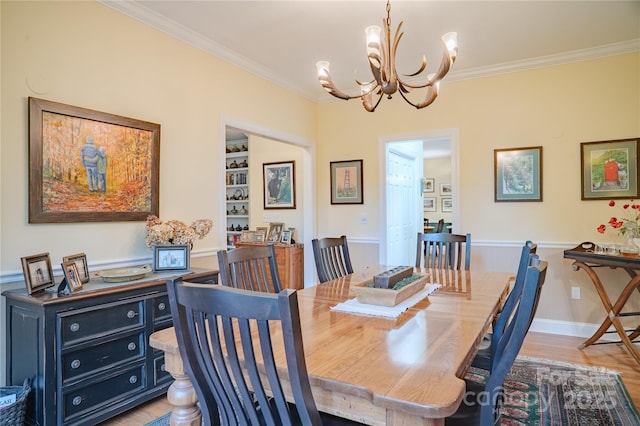 dining space with a chandelier, ornamental molding, and light wood-style flooring