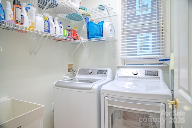 clothes washing area with washing machine and dryer