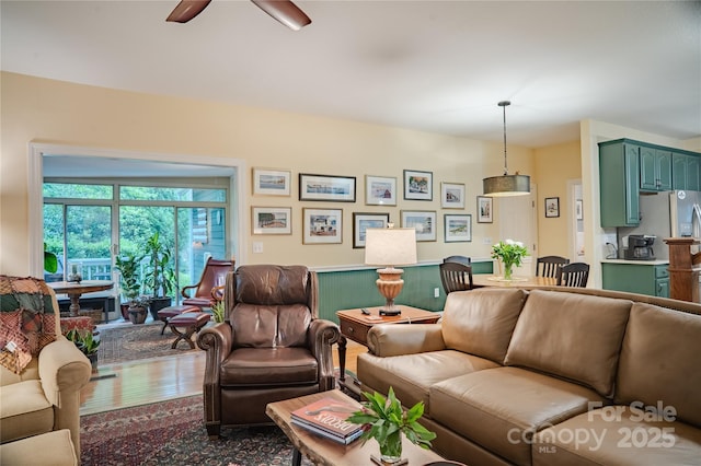 living area featuring a ceiling fan