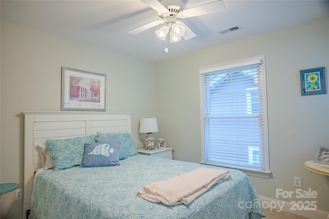 carpeted bedroom featuring baseboards and a ceiling fan