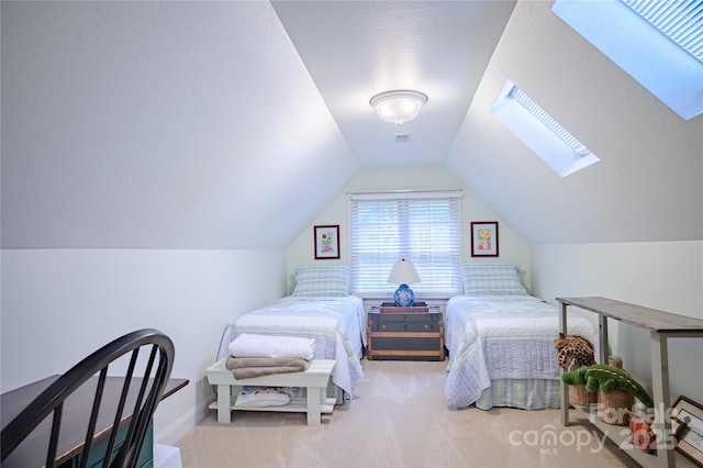 carpeted bedroom with lofted ceiling and a skylight