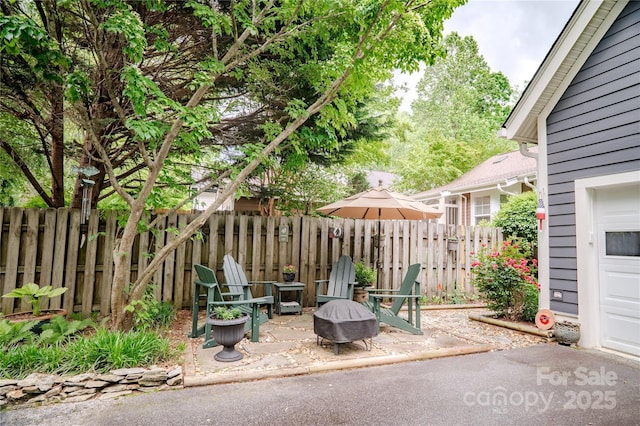 view of patio / terrace with fence and a fire pit