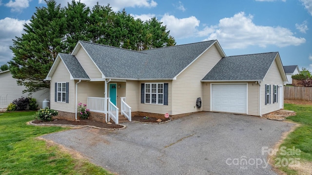 view of front of home featuring roof with shingles, a garage, and asphalt driveway