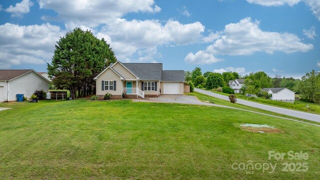 view of front of home with driveway, a garage, and a front yard