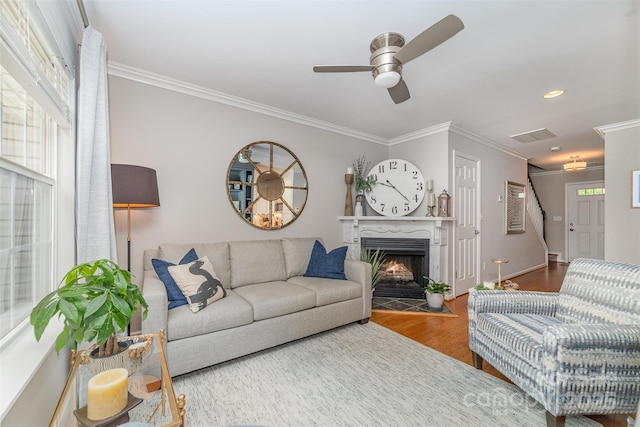 10617 Fuller Ridge Cir, Charlotte, NC 28270 - living room with ornamental molding, wood finished floors, ceiling fan, a tiled fireplace, and recessed lighting