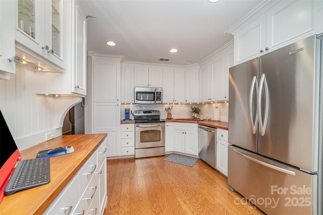 10617 Fuller Ridge Cir, Charlotte, NC 28270 - kitchen with butcher block counters, appliances with stainless steel finishes, white cabinetry, light wood finished floors, and recessed lighting