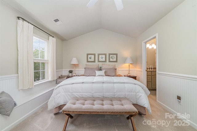 10617 Fuller Ridge Cir, Charlotte, NC 28270 - bedroom featuring wainscoting, vaulted ceiling, light carpet, and ceiling fan