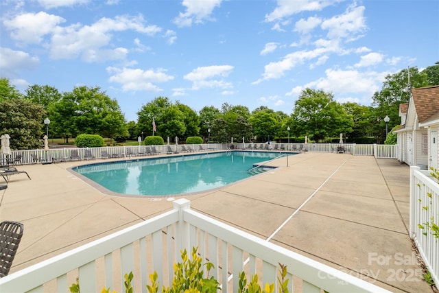 10617 Fuller Ridge Cir, Charlotte, NC 28270 - community pool with a patio, view of scattered trees, and fence