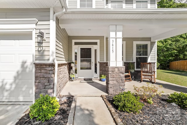 3615 Alamito Ln, Charlotte, NC 28214 - entrance to property with a porch, stone siding, and an attached garage