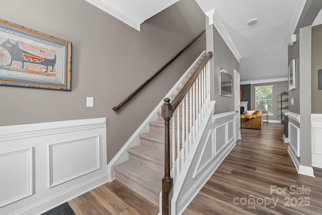 3615 Alamito Ln, Charlotte, NC 28214 - staircase with ornamental molding, wood finished floors, and a decorative wall