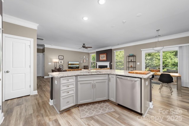 3615 Alamito Ln, Charlotte, NC 28214 - kitchen featuring stainless steel dishwasher, a sink, a ceiling fan, crown molding, and a fireplace