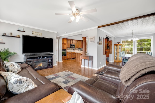 14 Phoenix Cir, Alexander, NC 28701 - living room featuring ceiling fan, light wood finished floors, baseboards, crown molding, and a chandelier