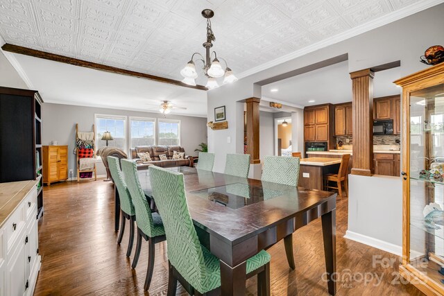 14 Phoenix Cir, Alexander, NC 28701 - dining space featuring dark wood-type flooring, ornamental molding, an ornate ceiling, a chandelier, and ornate columns