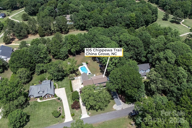 aerial view of property's location featuring a heavily wooded area