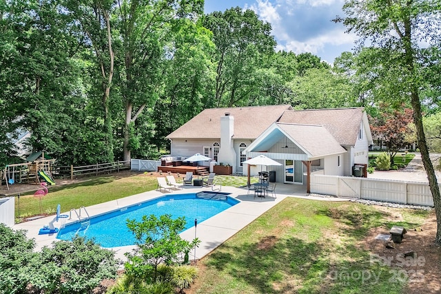 view of pool with a patio area and a playground
