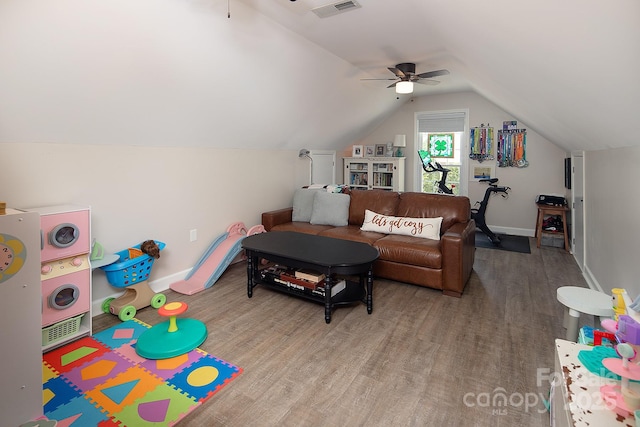 living room with ceiling fan, lofted ceiling, wood finished floors, and baseboards